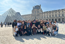 Students pose outside the Louvre in Paris.