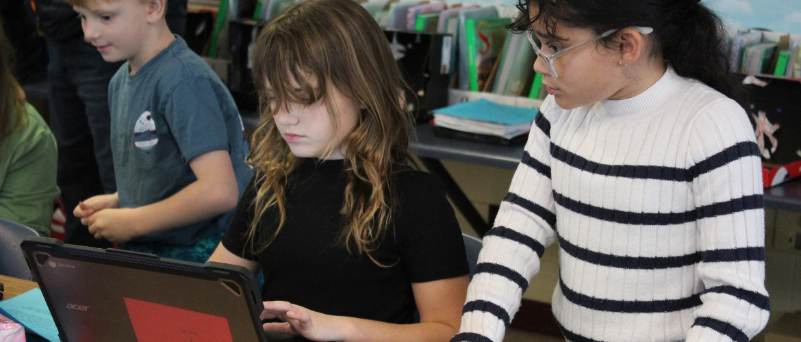 students working together on a chromebook