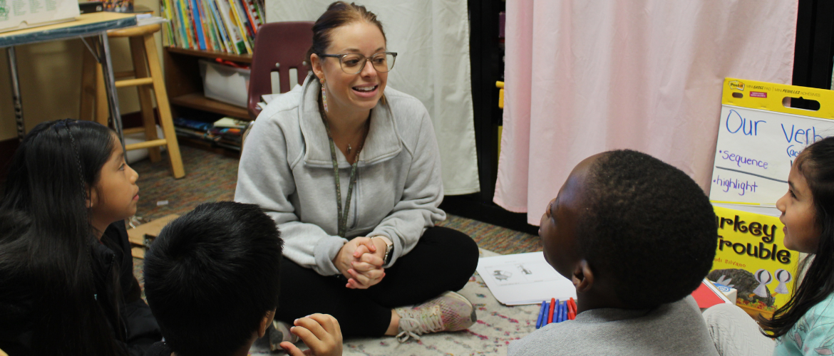 Teacher speaking with students